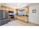 Modern kitchen with stainless steel appliances, tile backsplash, and ample wooden cabinets for storage at 12333 Edwards Pl, Denver, CO 80239