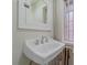 Bathroom featuring a pedestal sink, medicine cabinet, and window at 1410 Vine St # 1, Denver, CO 80206