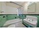 Bathroom with colorful tile, shower and bathtub combo, and large basin sink at 1410 Vine St # 1, Denver, CO 80206