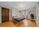 Bedroom featuring murphy bed, hardwood floors, neutral walls, and natural light at 1410 Vine St # 1, Denver, CO 80206