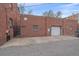 Brick building exterior with gated private parking and garage entrance at 1410 Vine St # 1, Denver, CO 80206