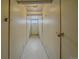 Hallway with individual storage units, padlocked doors, and a window at the end at 1410 Vine St # 1, Denver, CO 80206