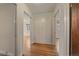 Hallway view showcasing hardwood floors, fresh white paint and a storage closet at 1410 Vine St # 1, Denver, CO 80206