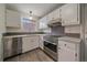 Modern kitchen featuring stainless steel appliances, stylish backsplash, and ample counter space at 1410 Vine St # 1, Denver, CO 80206
