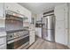 Modern kitchen featuring stainless steel appliances, stylish backsplash, and white cabinets at 1410 Vine St # 1, Denver, CO 80206