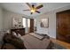 Bedroom with ensuite bathroom, hardwood floors, neutral walls, and ceiling fan at 1410 Vine St # 1, Denver, CO 80206