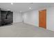 Large finished basement featuring carpeted flooring, a wood-burning stove, and ample space for recreation or storage at 7736 Vallejo St, Denver, CO 80221