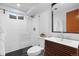 Modern bathroom with a glass enclosed shower, stylish vanity, tiled walls, and updated fixtures at 7736 Vallejo St, Denver, CO 80221