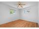 Cozy bedroom featuring a ceiling fan, hardwood floors, and dual windows offering natural light and neighborhood views at 7736 Vallejo St, Denver, CO 80221