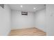 Small bedroom or bonus room with wood floors, a small window, and white walls at 7736 Vallejo St, Denver, CO 80221