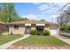Charming one-story brick home with well-maintained lawn and awning-covered windows at 7736 Vallejo St, Denver, CO 80221