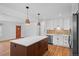 Bright kitchen featuring white cabinets, stainless steel appliances, and a butcher block island at 7736 Vallejo St, Denver, CO 80221