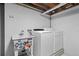 Functional laundry area featuring a utility sink with stickers and a new washer and dryer set at 7736 Vallejo St, Denver, CO 80221