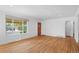 Bright living room with hardwood floors and a large picture window overlooking the yard at 7736 Vallejo St, Denver, CO 80221