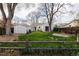 Expansive backyard showcasing lush greenery, a shed, and mature trees at 3910 S Grant St, Englewood, CO 80113