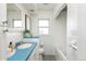Bright bathroom featuring blue countertops, white tiling, and stylish fixtures at 3910 S Grant St, Englewood, CO 80113