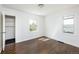 Sunlit bedroom showcasing gleaming hardwood floors and two bright windows at 3910 S Grant St, Englewood, CO 80113