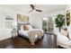 Cozy bedroom with hardwood floors, ceiling fan, and sliding door to outside at 3910 S Grant St, Englewood, CO 80113