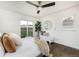 Bedroom with hardwood floors, ceiling fan, bed, sliding glass doors, and sitting area at 3910 S Grant St, Englewood, CO 80113