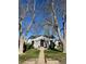 Charming single-story home with a cozy front yard framed by mature trees on a sunny day at 3910 S Grant St, Englewood, CO 80113