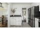Bright kitchen with stainless steel refrigerator, stone countertops and view into other rooms at 3910 S Grant St, Englewood, CO 80113