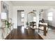 Bright living room featuring hardwood floors, a large gold mirror and access to the dining room at 3910 S Grant St, Englewood, CO 80113
