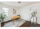 Bright home office has a wooden desk, neutral rug, and white walls at 3910 S Grant St, Englewood, CO 80113