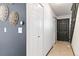 Inviting entryway with tan tiled floor, decorative wall art, a front door and convenient closet storage at 1693 Carr St # A, Lakewood, CO 80214