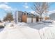 Snow covered exterior of a two-story townhome with attached garage at 1693 Carr St # A, Lakewood, CO 80214