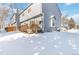 Exterior view of the home showing a snow-covered backyard and deck at 1693 Carr St # A, Lakewood, CO 80214