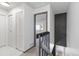 Bright hallway with white walls and contrasting black accents, leading to additional rooms and closet space at 1693 Carr St # A, Lakewood, CO 80214