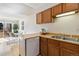 Efficient kitchen with light wood counters and cabinets, stainless steel sink, and access to dining and patio at 1693 Carr St # A, Lakewood, CO 80214