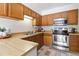 Functional kitchen with wooden cabinetry, stainless steel appliances, and ample countertop space at 1693 Carr St # A, Lakewood, CO 80214