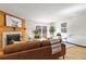 Cozy living room with wood-burning fireplace, sliding door to deck, and dining area at 1693 Carr St # A, Lakewood, CO 80214