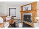 Comfortable living room featuring a wood-burning fireplace and a cozy seating arrangement on hardwood floors at 1693 Carr St # A, Lakewood, CO 80214