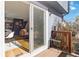 View from a patio with wooden railing, through sliding glass doors, into the living room and kitchen at 1693 Carr St # A, Lakewood, CO 80214