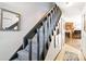 Interior view of a carpeted staircase with dark wood railing at 1693 Carr St # A, Lakewood, CO 80214