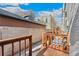 Private back porch featuring a wooden deck, railing, and a secure gate for added privacy at 1914 E 16Th Ave, Denver, CO 80206