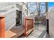 Charming back porch with wooden deck, metal gate, and secure entry for outdoor relaxation at 1914 E 16Th Ave, Denver, CO 80206