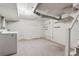 Clean basement with white-painted brick walls, carpeted floor, and utility connections at 1914 E 16Th Ave, Denver, CO 80206