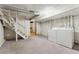 Spacious basement featuring painted brick walls, carpeted floors, and a laundry area with modern appliances at 1914 E 16Th Ave, Denver, CO 80206