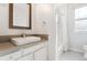 Modern bathroom with white subway tile, glass shower, and a large vanity mirror at 1914 E 16Th Ave, Denver, CO 80206