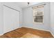 Bedroom featuring hardwood floors, a closet with standard doors and lots of natural light at 1914 E 16Th Ave, Denver, CO 80206