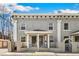 Charming brick townhouse with white pillars and a welcoming front porch at 1914 E 16Th Ave, Denver, CO 80206