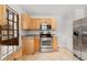 Well-lit kitchen with stainless steel oven, granite counters, and natural wood cabinets at 1914 E 16Th Ave, Denver, CO 80206