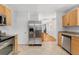 Kitchen featuring stainless steel appliances and tile flooring leading into the living room at 1914 E 16Th Ave, Denver, CO 80206