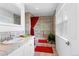 Tiled bathroom featuring a soaking tub, vanity, and window for natural light at 13304 E Asbury Dr, Aurora, CO 80014