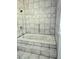 Close-up of the bathtub in a bathroom with tiled walls and flooring at 13304 E Asbury Dr, Aurora, CO 80014