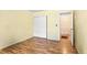 Bright bedroom featuring wood flooring, a closet, and an adjoining door at 13304 E Asbury Dr, Aurora, CO 80014