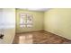This is a sunny bedroom with a large window and wood flooring at 13304 E Asbury Dr, Aurora, CO 80014